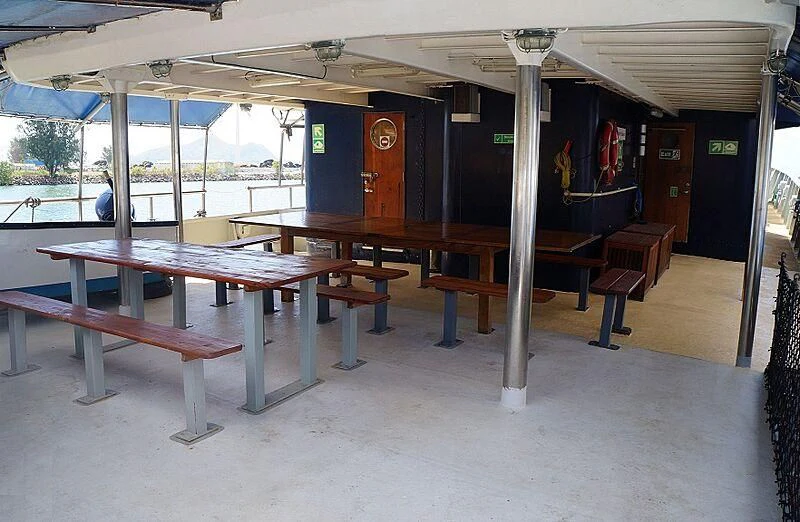 a long table with benches aboard MAYA'S DUGONG Yacht for Sale