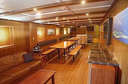 a large room with a couch and a table aboard MAYA'S DUGONG Yacht for Sale