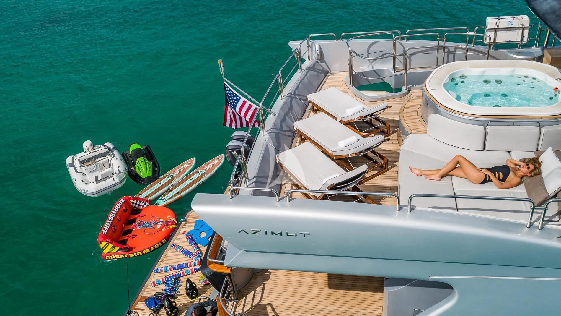a person lying on a lounge chair on a boat on the water aboard TAIL LIGHTS Yacht for Sale