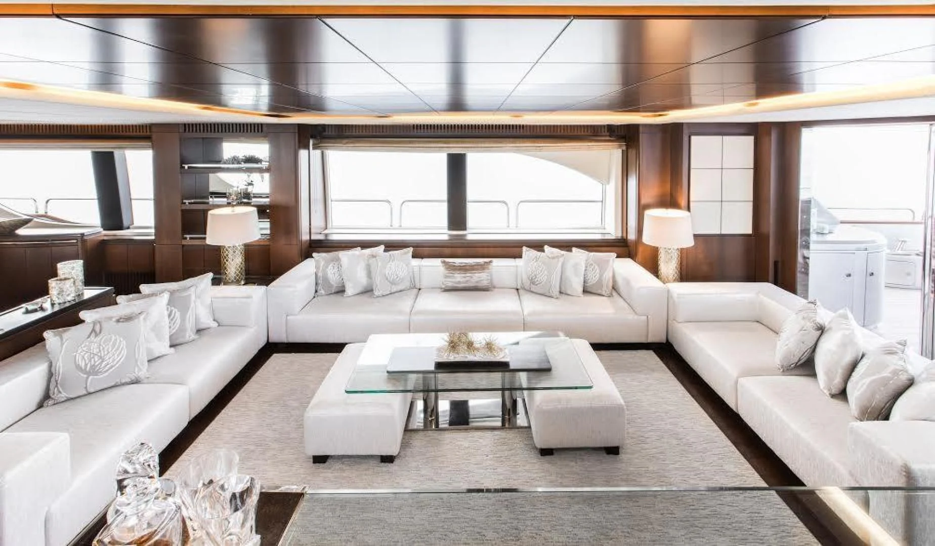 a living room with a large white couch and a large window aboard TAIL LIGHTS Yacht for Sale