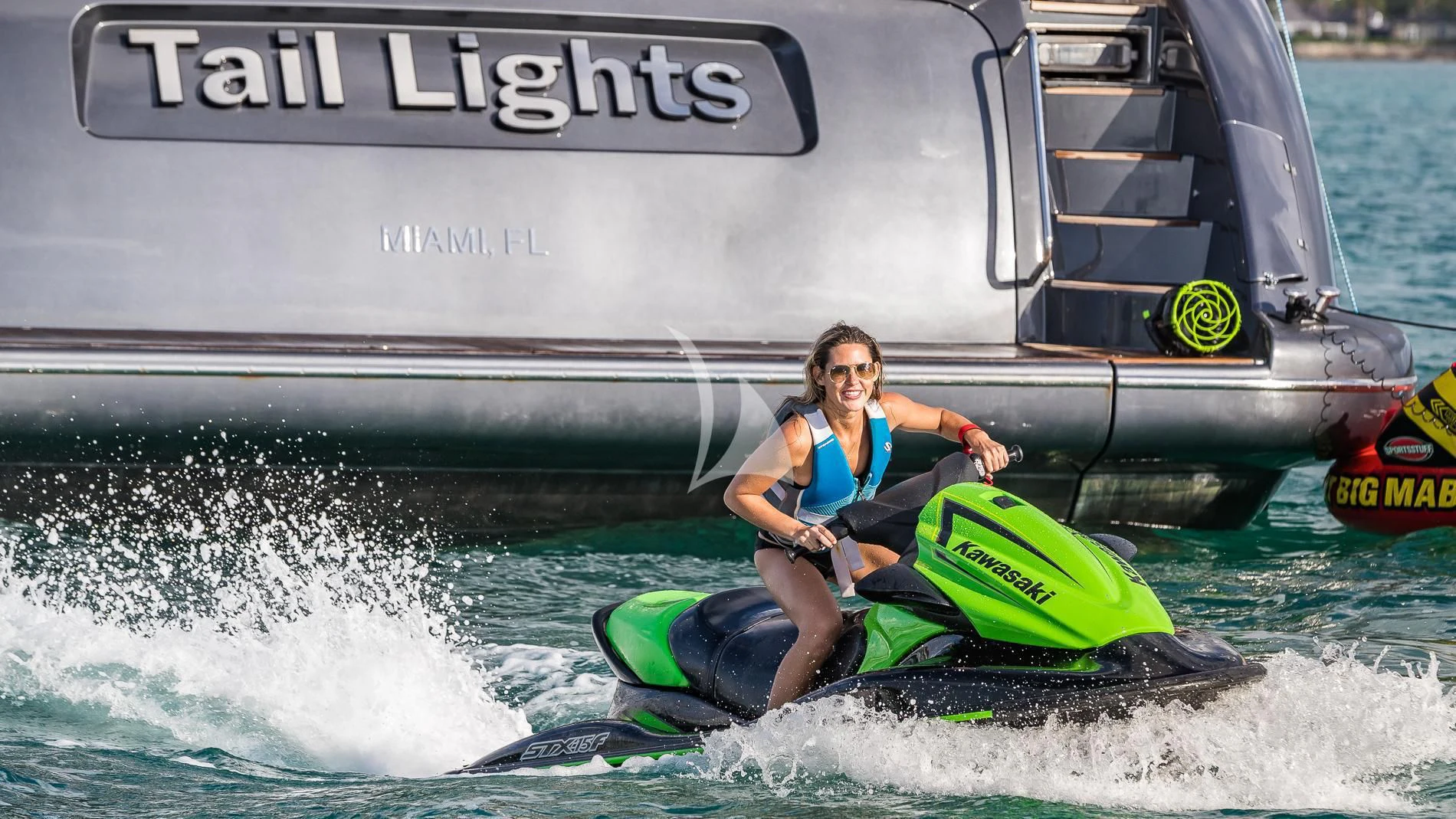 a man on a jet ski aboard TAIL LIGHTS Yacht for Sale