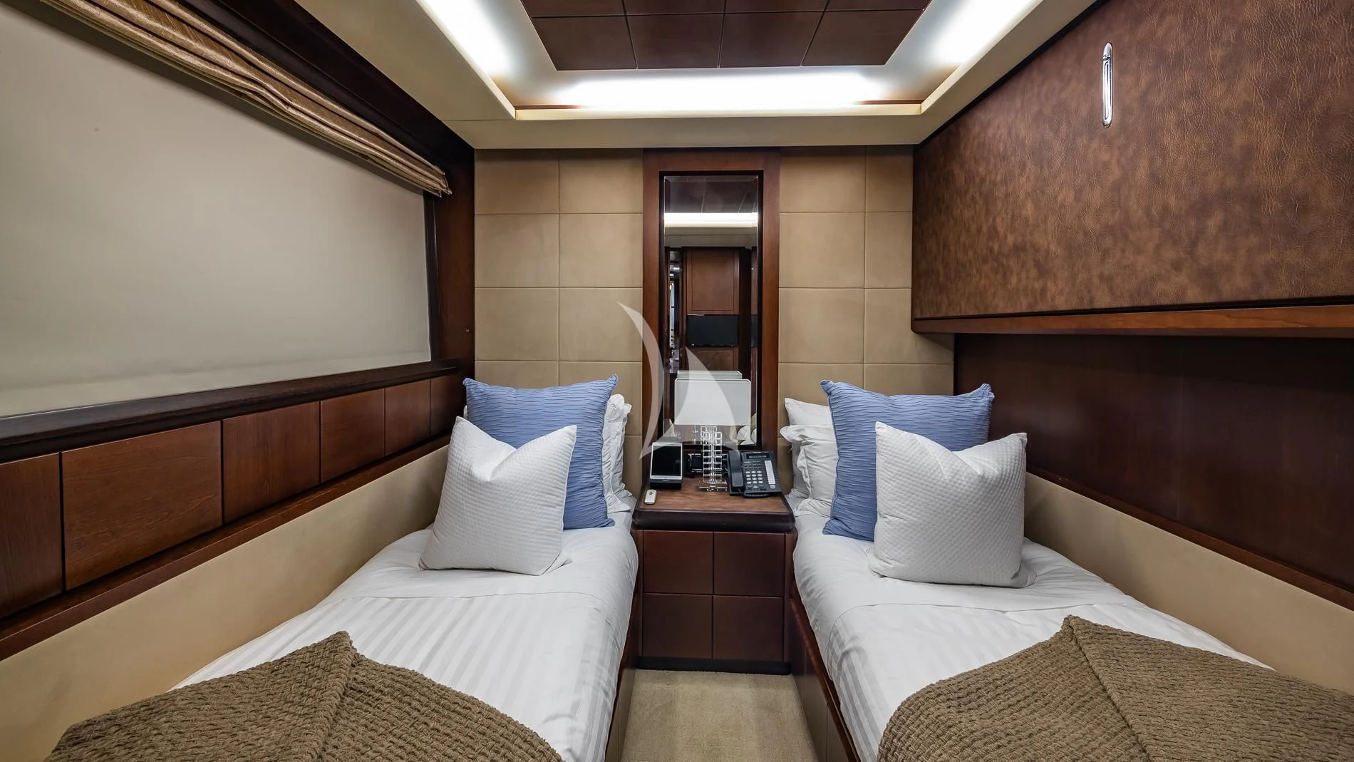 a room with beds and a mirror aboard TAIL LIGHTS Yacht for Sale