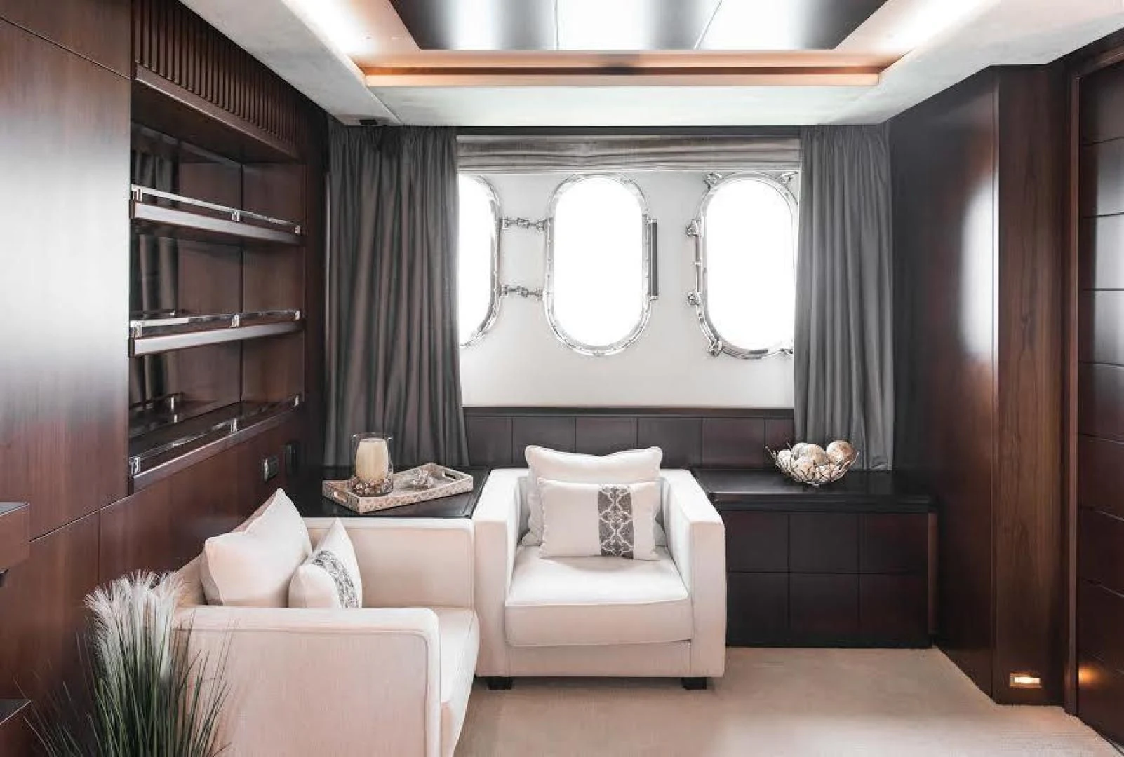 a room with a mirror and couches aboard TAIL LIGHTS Yacht for Sale