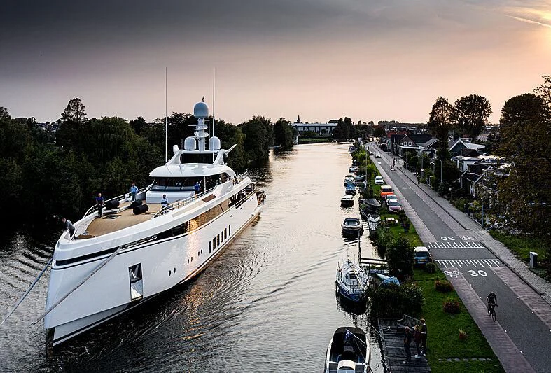 a boat travels down the river aboard TOTALLY NUTS Yacht for Sale