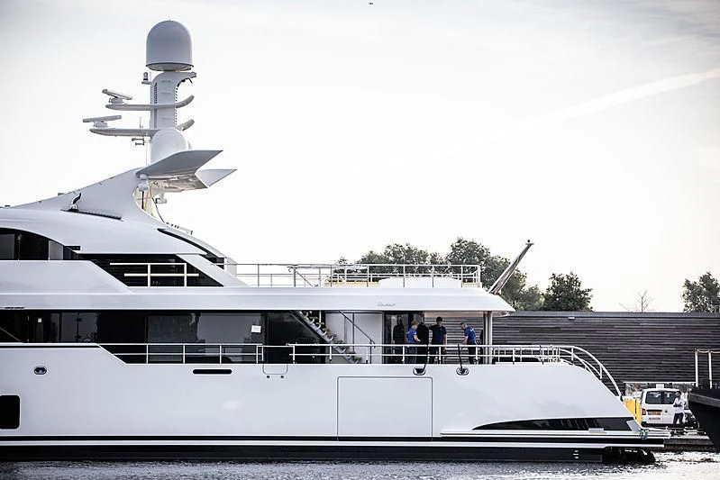 a boat docked with people standing on the deck aboard TOTALLY NUTS Yacht for Sale