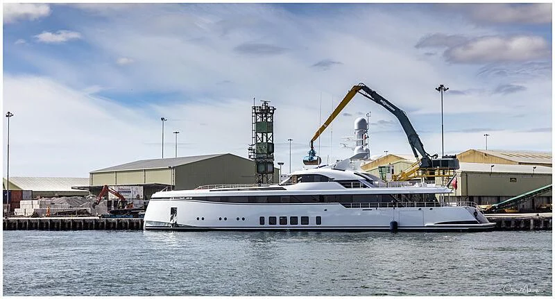 a large white boat in a harbor aboard TOTALLY NUTS Yacht for Sale