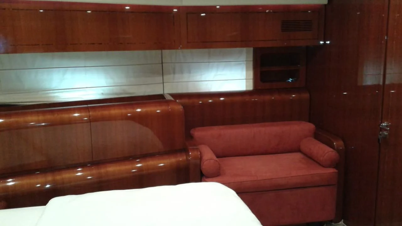 a room with a couch and a window aboard PRINCESS AYESHA I Yacht for Sale