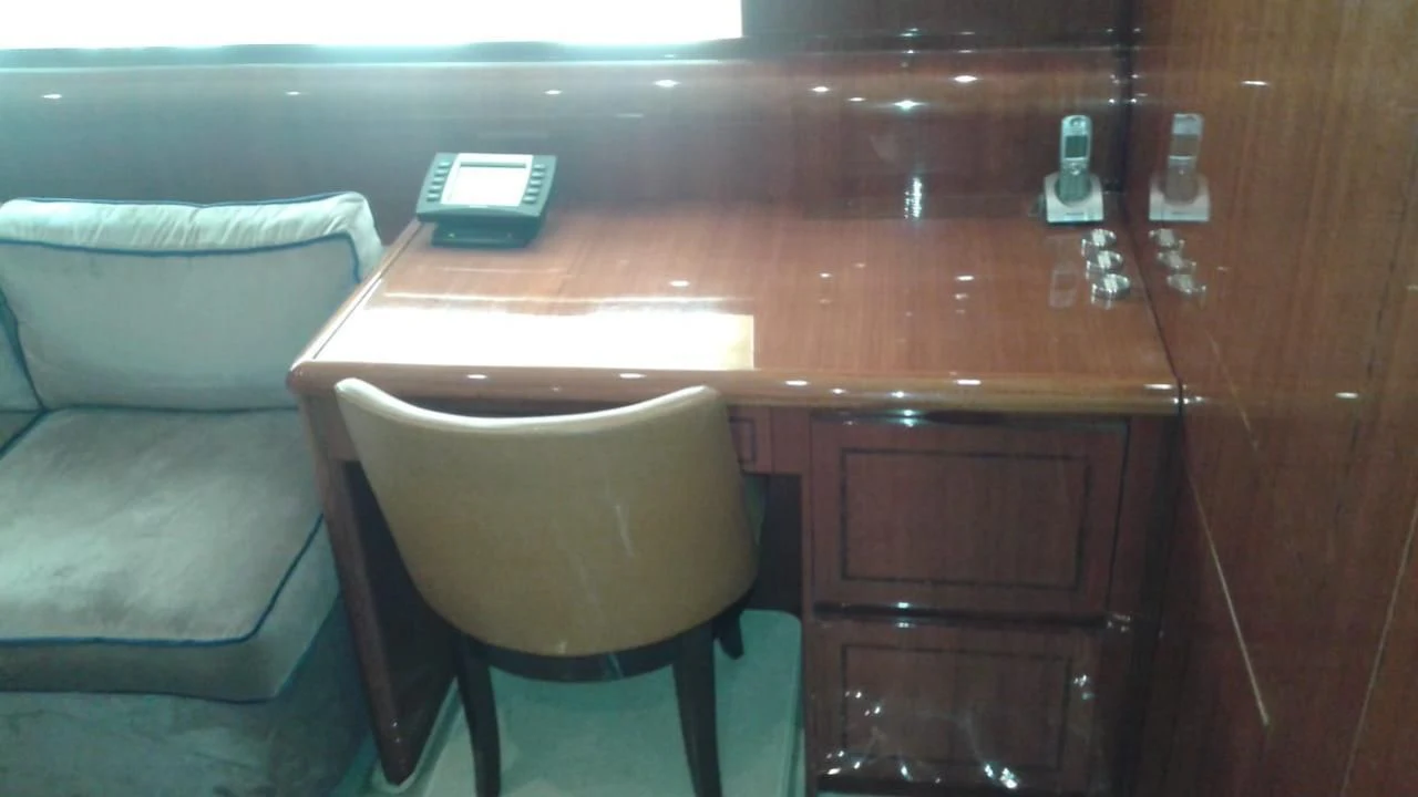 a desk with a chair and a computer on it aboard PRINCESS AYESHA I Yacht for Sale