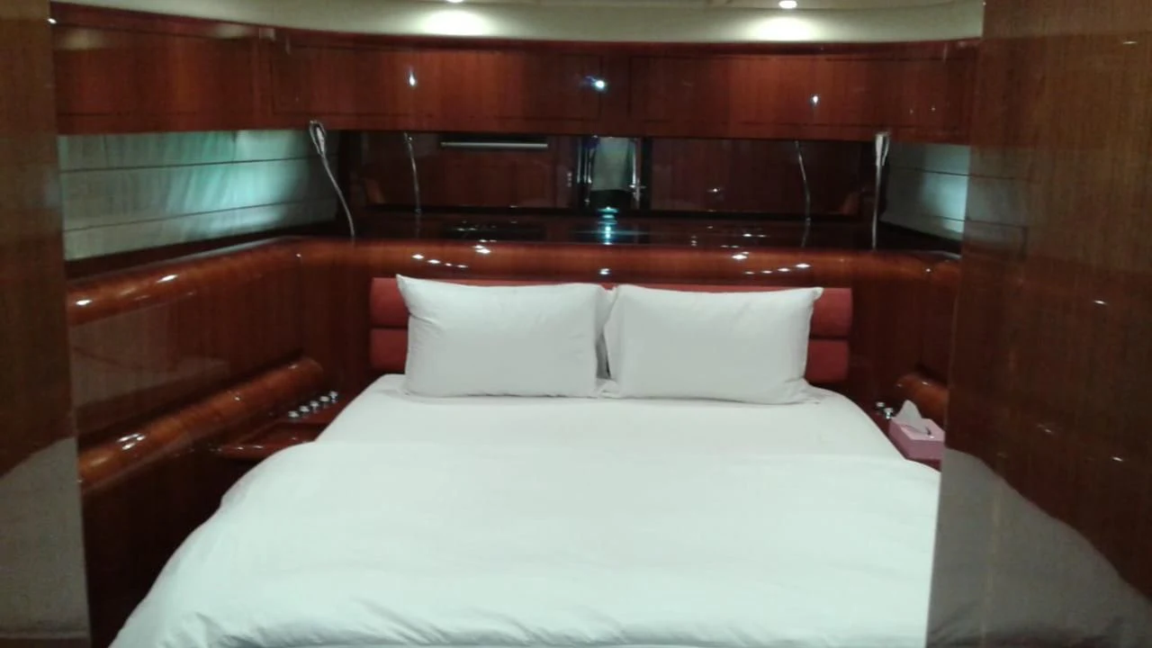 a bed with white sheets aboard PRINCESS AYESHA I Yacht for Sale