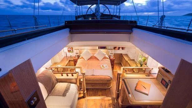 a room with a view of the ocean and the ocean aboard PUMULA Yacht for Sale