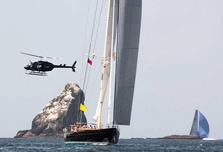 a helicopter flying over a boat aboard PUMULA Yacht for Sale