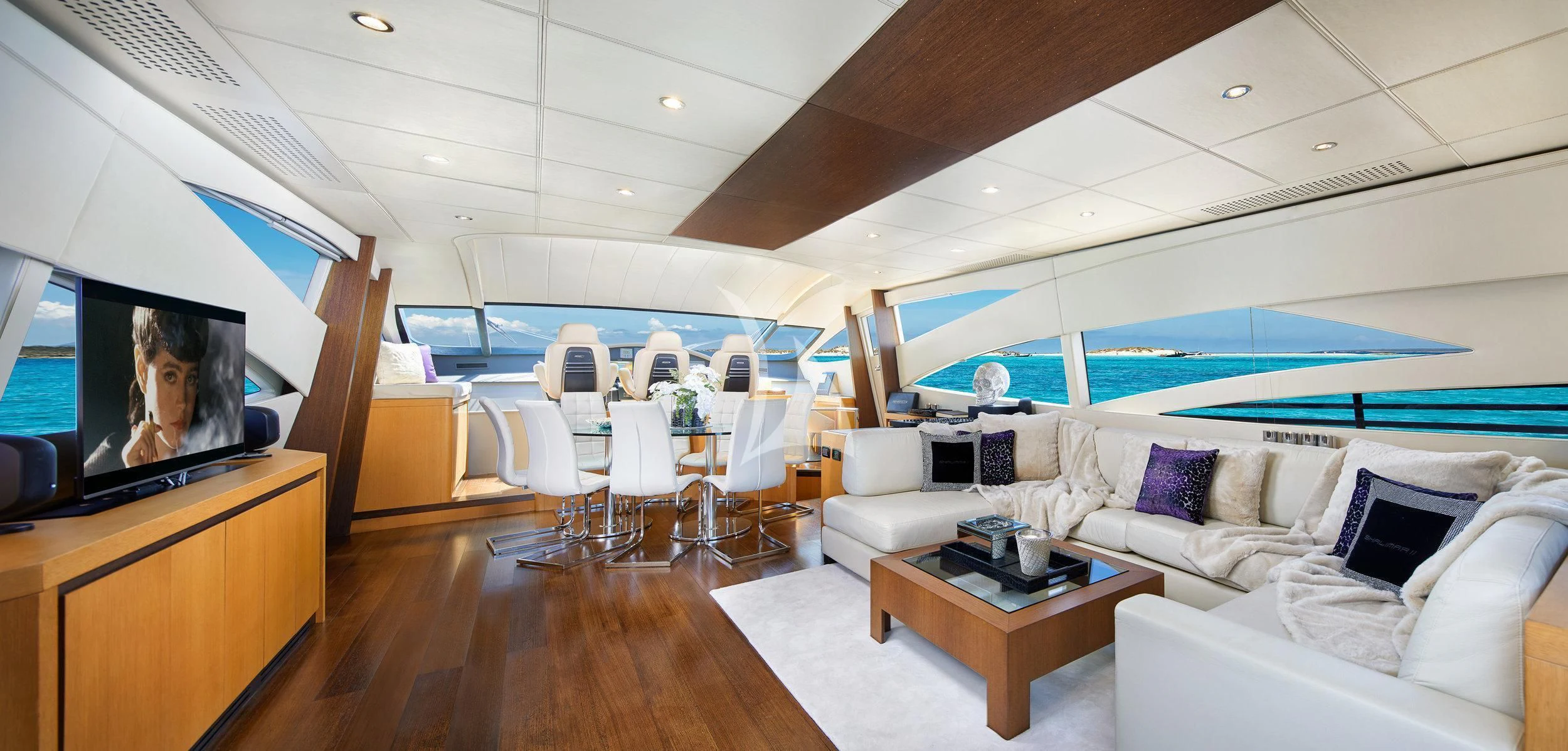 a living room with a large screen aboard XAMAN Yacht for Sale