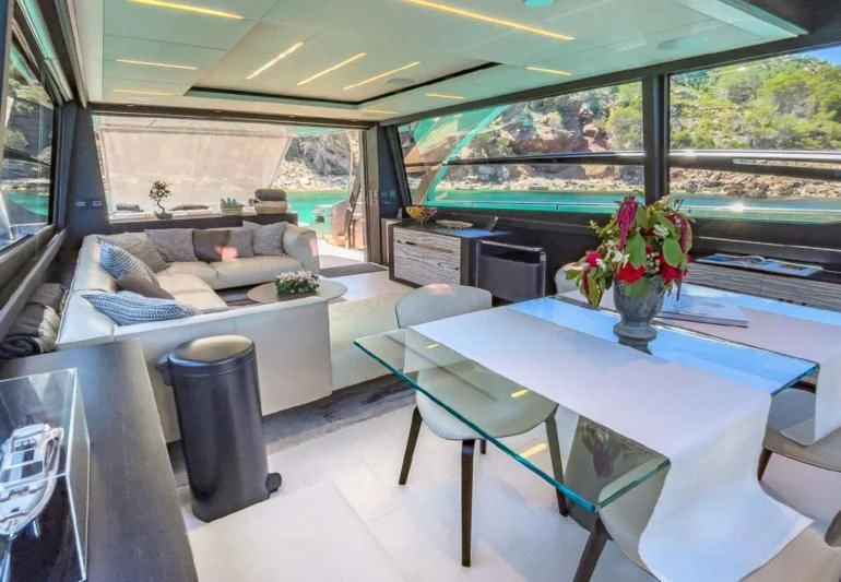 a room with a table and chairs aboard XAMAN Yacht for Sale