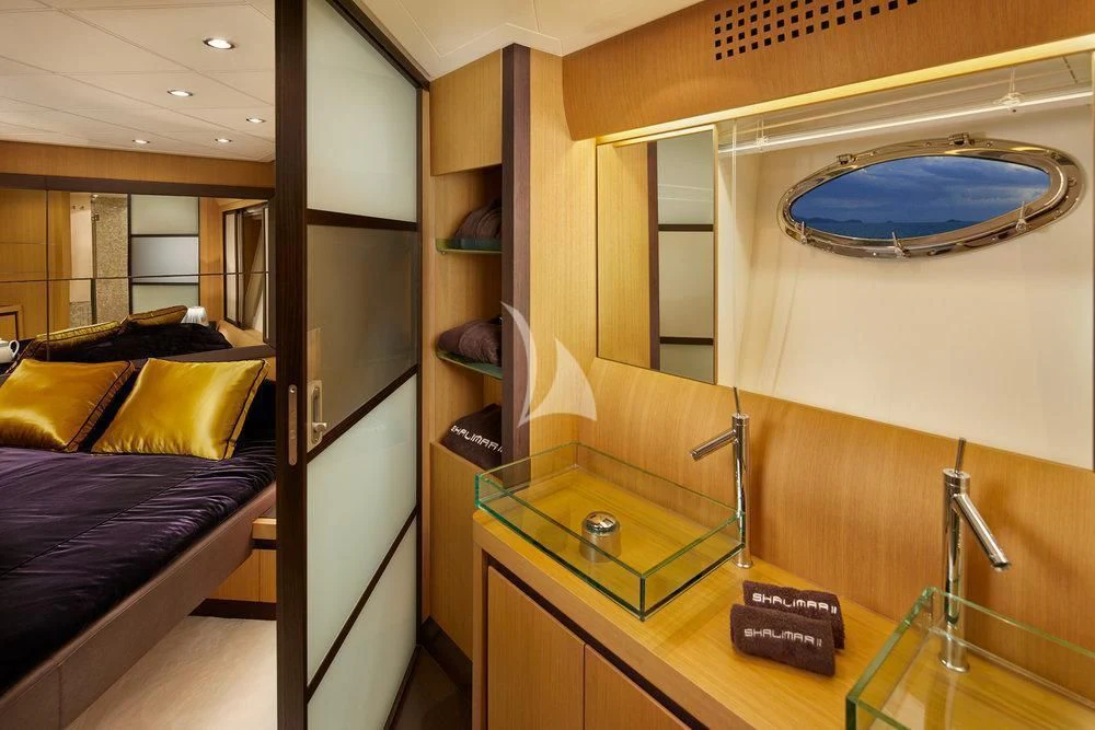 a room with a bed and a desk aboard XAMAN Yacht for Sale