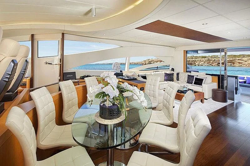 a room with a table chairs and a large window aboard XAMAN Yacht for Sale