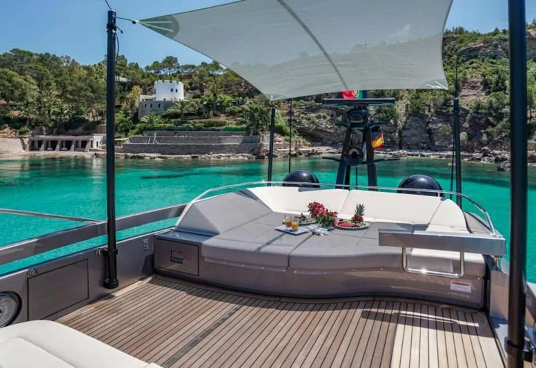 a pool with a table and chairs aboard XAMAN Yacht for Sale