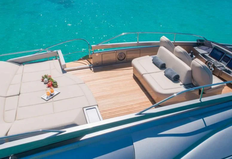 a balcony with a table and chairs aboard XAMAN Yacht for Sale