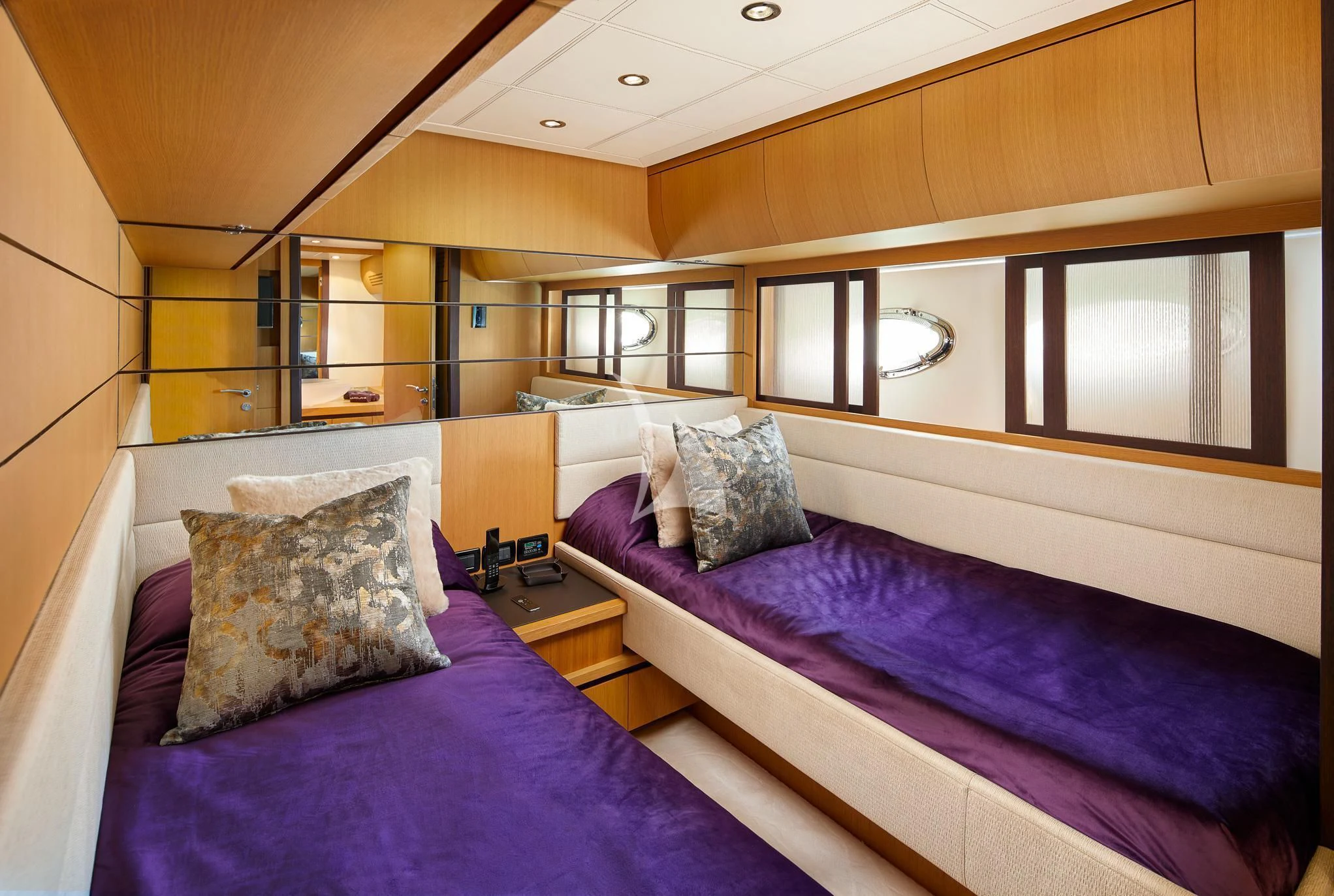 a bed with purple sheets aboard XAMAN Yacht for Sale