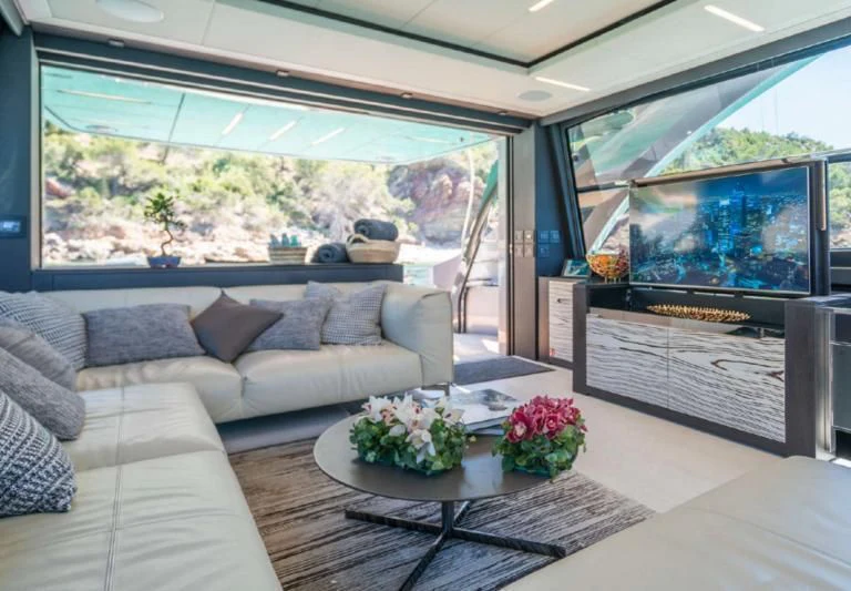 a living room with a large window aboard XAMAN Yacht for Sale