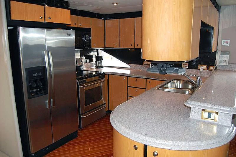 a kitchen with stainless steel appliances aboard MOONSHINE Yacht for Sale