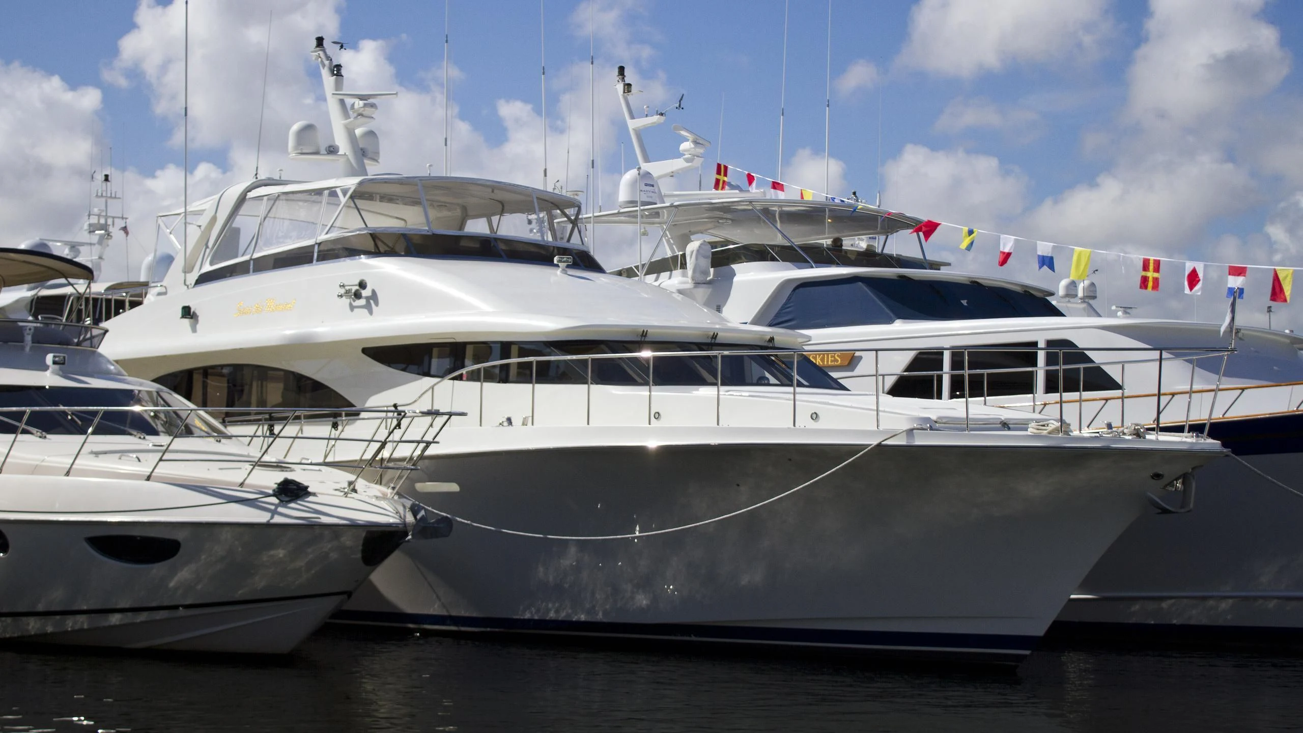 a few white yachts on a dock aboard MOONSHINE Yacht for Sale