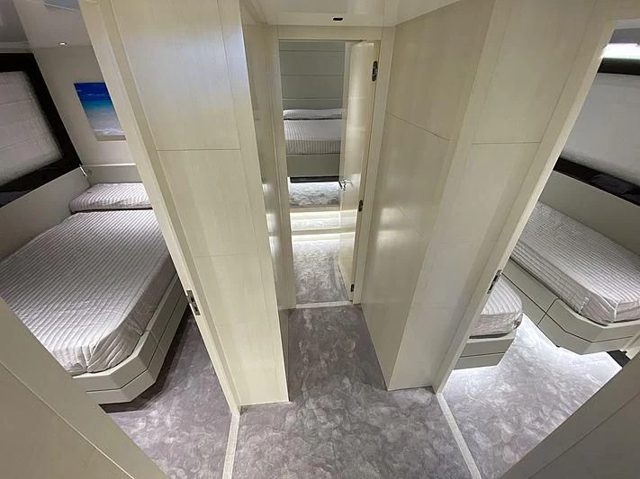 a room with a bed and a door aboard PASSION VI Yacht for Sale