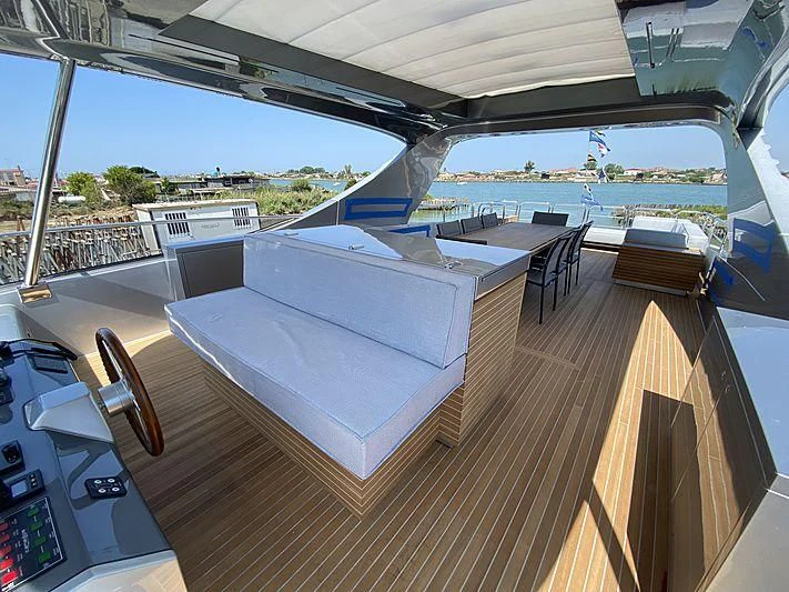 a deck with a deck and chairs aboard PASSION VI Yacht for Sale