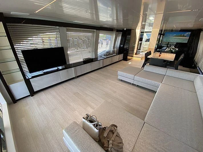 a room with a couch and a tv aboard PASSION VI Yacht for Sale