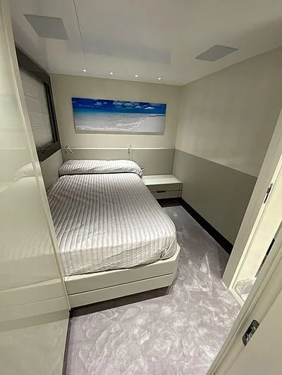 a small bedroom with a bed aboard PASSION VI Yacht for Sale