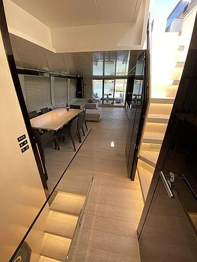 a hallway with a table and chairs aboard PASSION VI Yacht for Sale