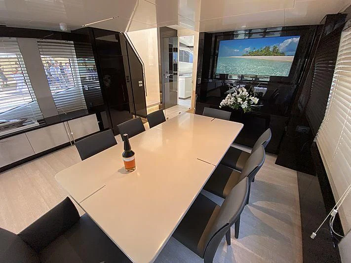 a conference room with a table and chairs aboard PASSION VI Yacht for Sale