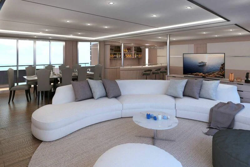 a living room with a large sofa aboard INDEPENDENCE 135 Yacht for Sale