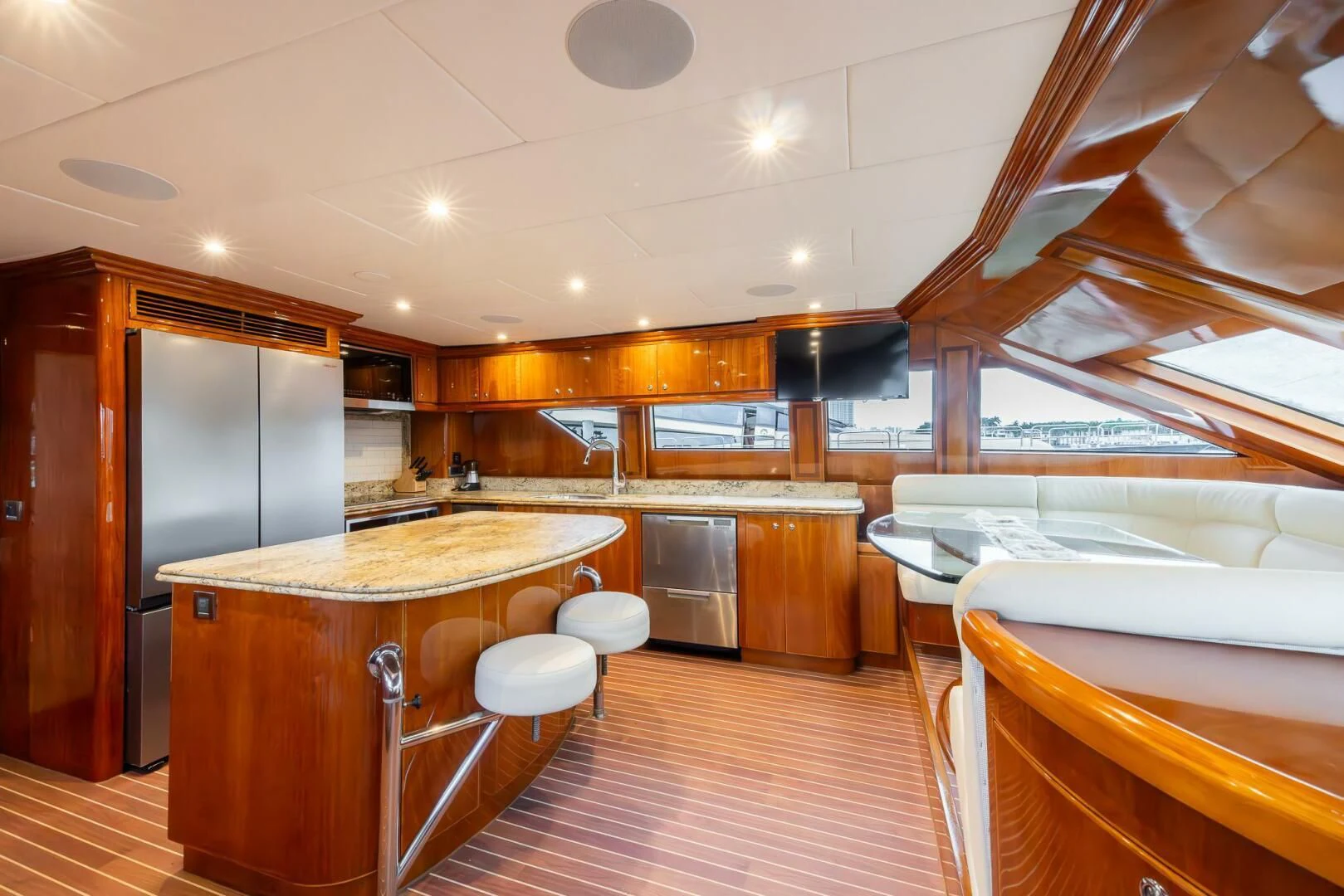 a large kitchen with a bar and fridge aboard OCEAN 1 Yacht for Sale