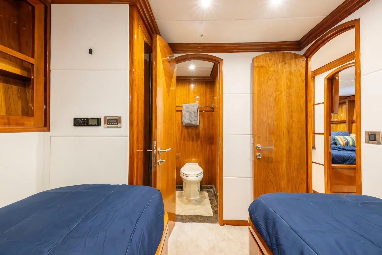 a bedroom with a bed and a closet aboard OCEAN 1 Yacht for Sale
