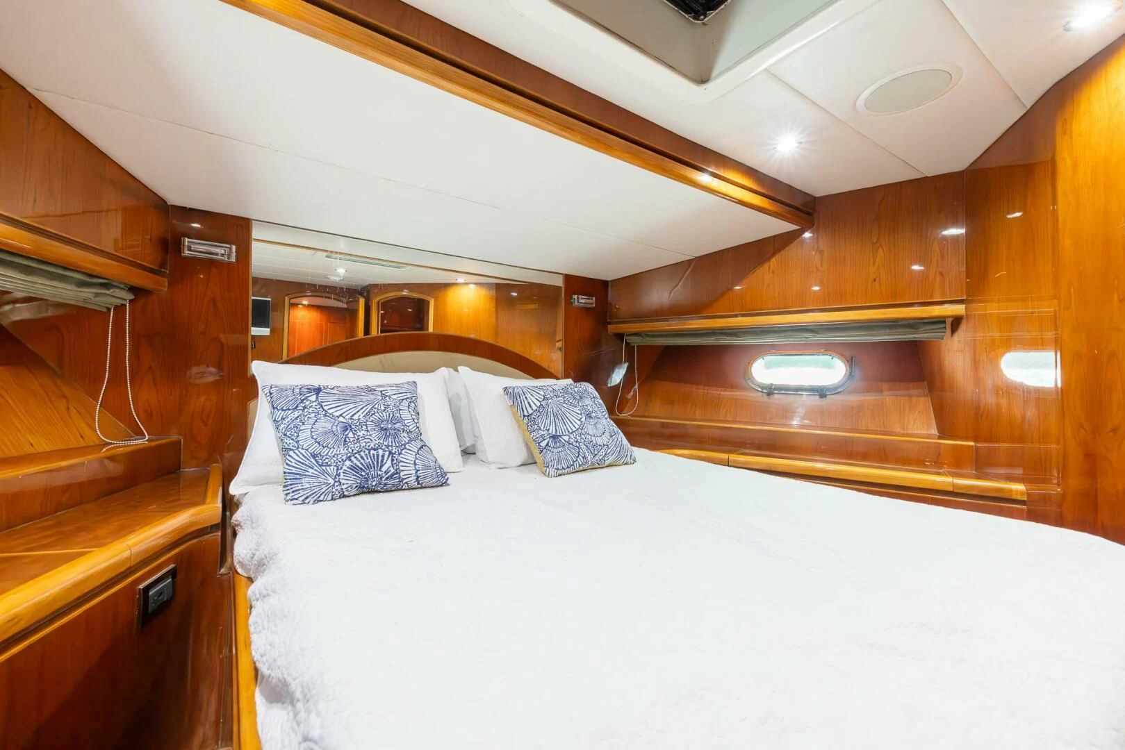 a room with a bed and a wood wall aboard OCEAN 1 Yacht for Sale