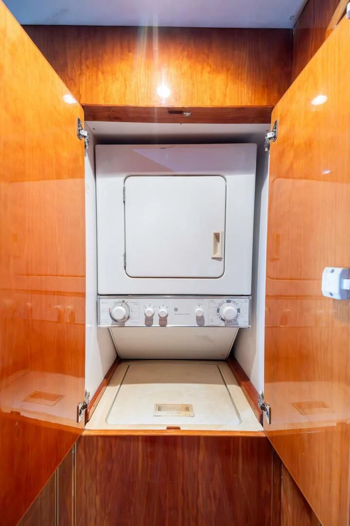 a microwave oven in a wooden cabinet aboard OCEAN 1 Yacht for Sale