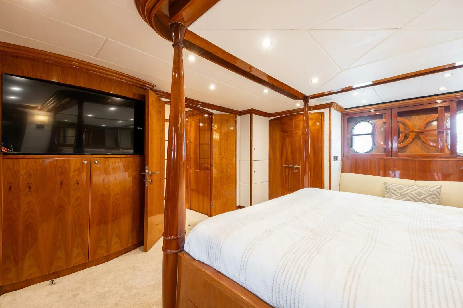 a bedroom with wood furniture aboard OCEAN 1 Yacht for Sale
