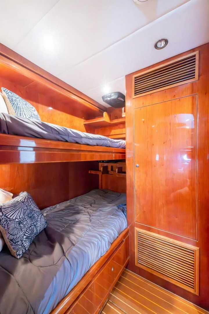 a bedroom with a wood closet aboard OCEAN 1 Yacht for Sale