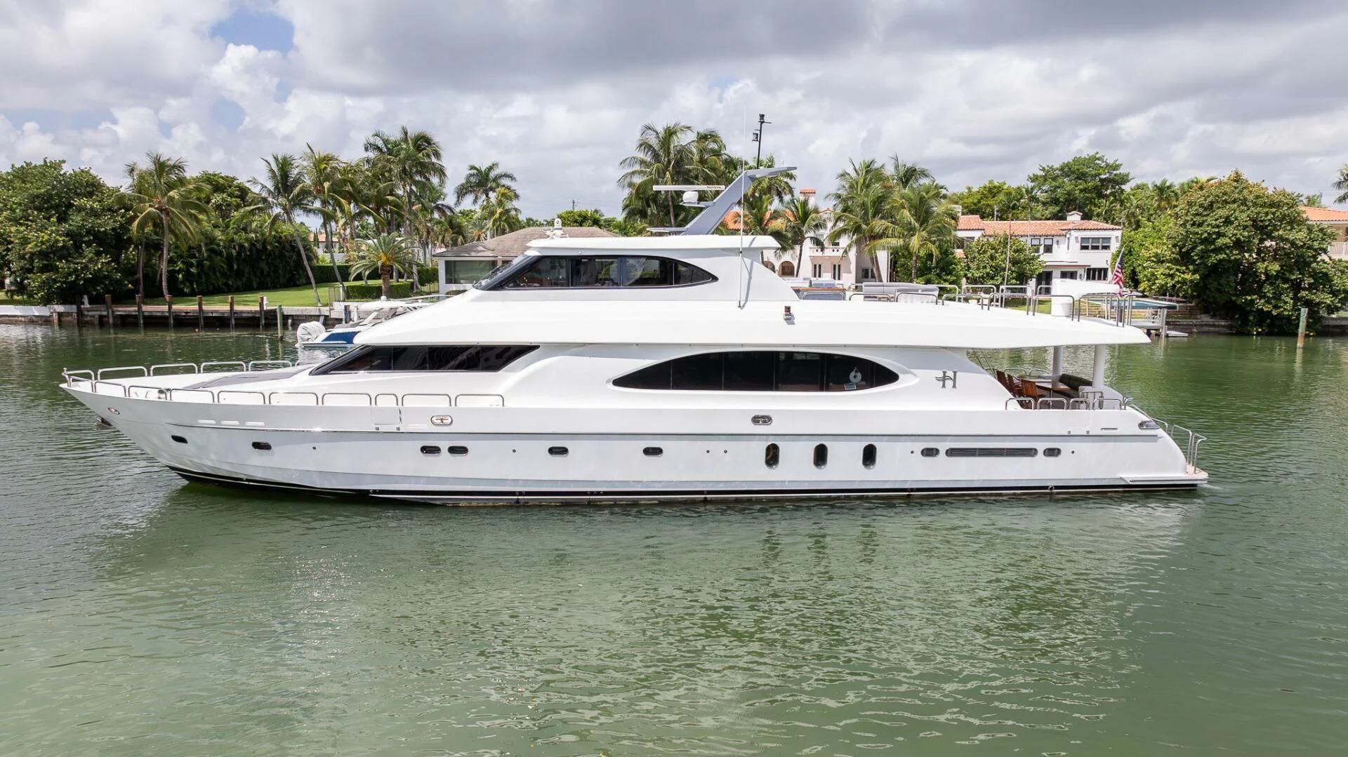 a white yacht in a harbor aboard OCEAN 1 Yacht for Sale