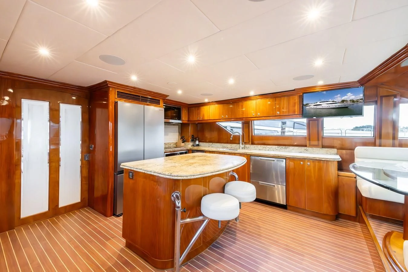 a kitchen with a bar and stools aboard OCEAN 1 Yacht for Sale