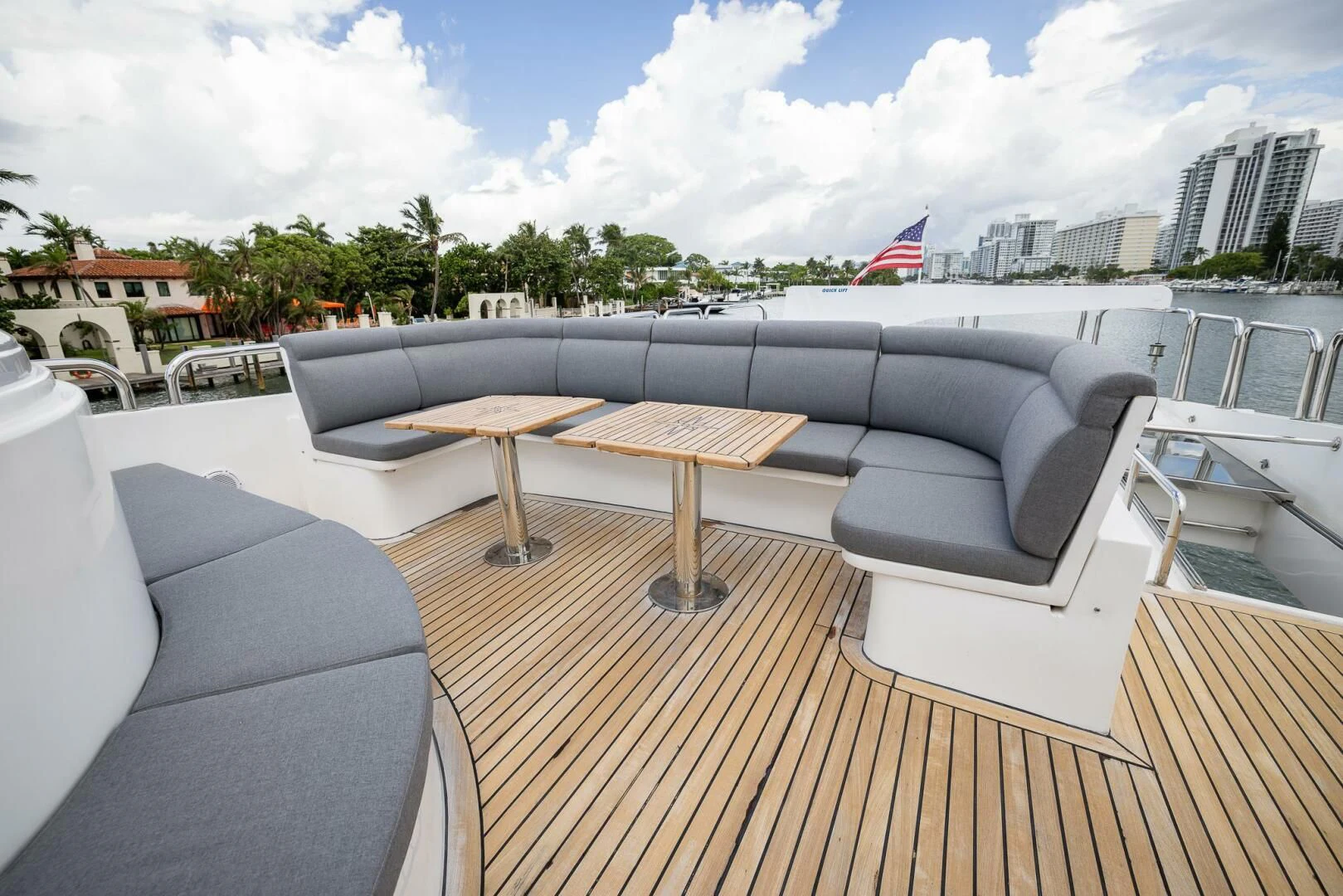 a deck with a table and chairs on it aboard OCEAN 1 Yacht for Sale
