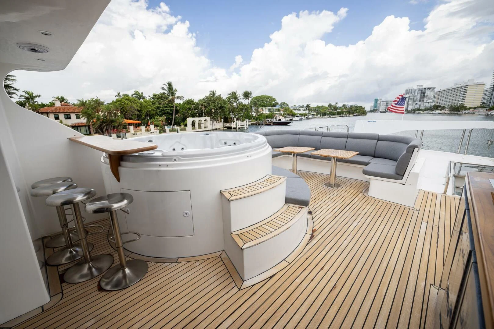 a large white bathtub on a deck with chairs and tables aboard OCEAN 1 Yacht for Sale