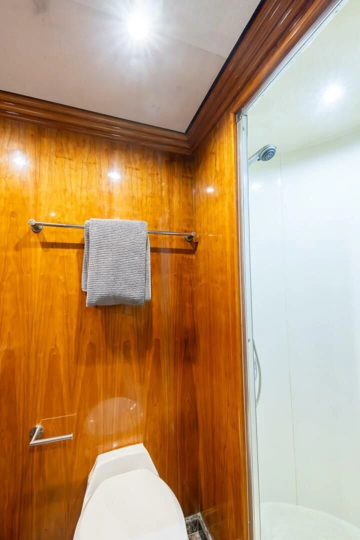 a bathroom with a toilet and wooden walls aboard OCEAN 1 Yacht for Sale