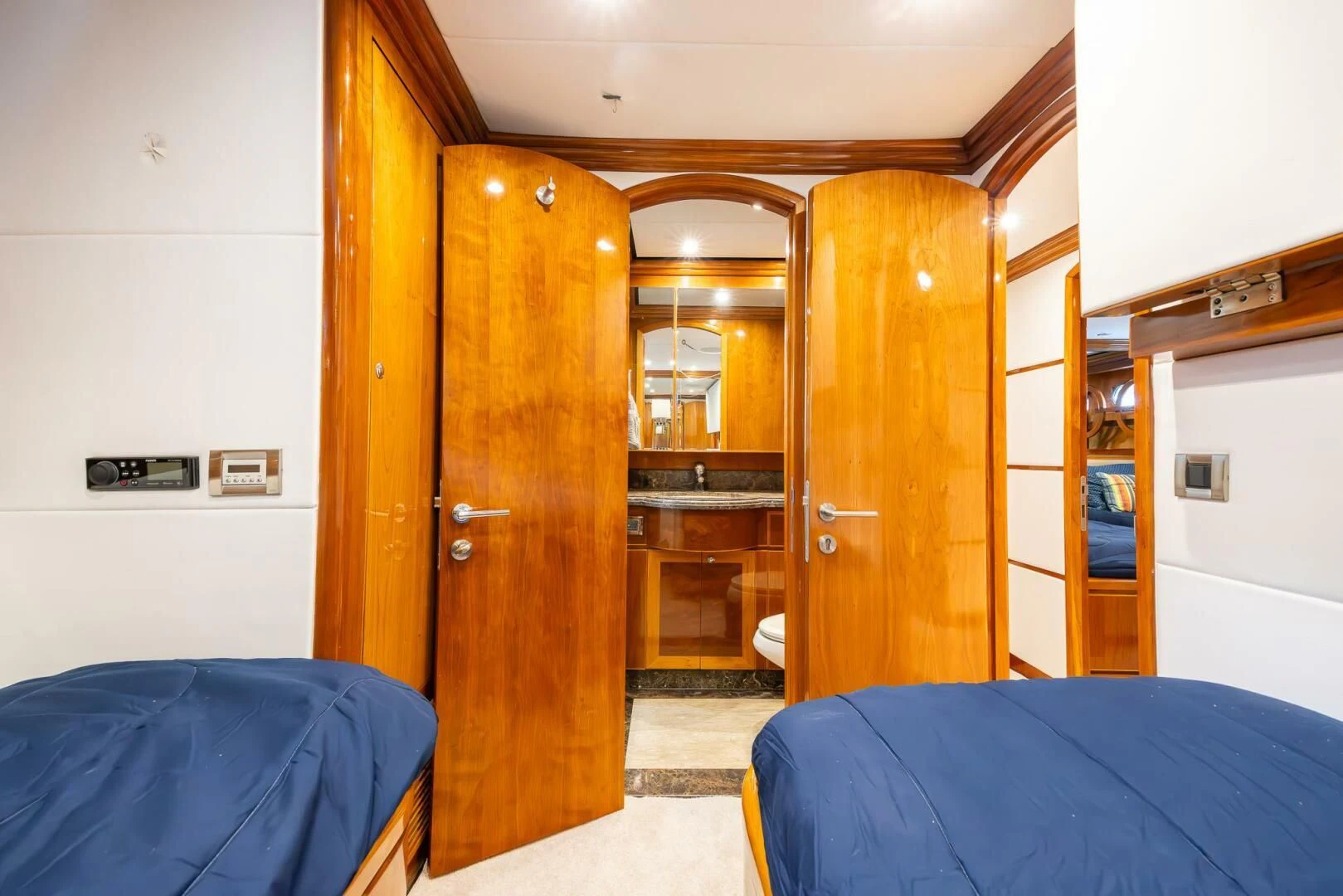 a bedroom with a bed and a closet aboard OCEAN 1 Yacht for Sale