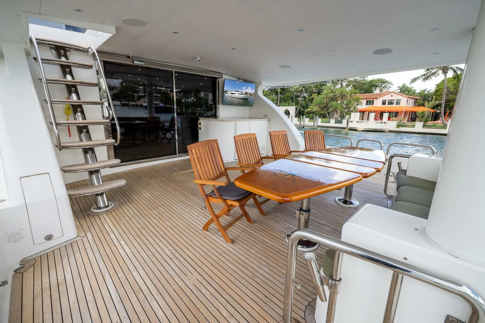 a room with a table chairs and a shelf with books on it aboard OCEAN 1 Yacht for Sale