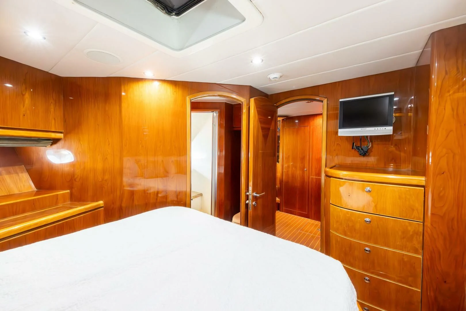 a room with a bed and a television aboard OCEAN 1 Yacht for Sale