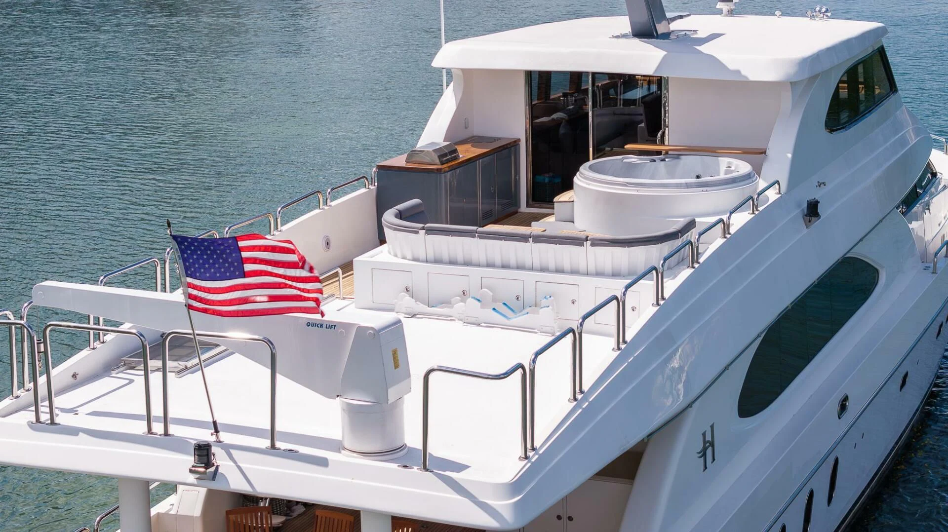 a boat with a flag on the front aboard OCEAN 1 Yacht for Sale