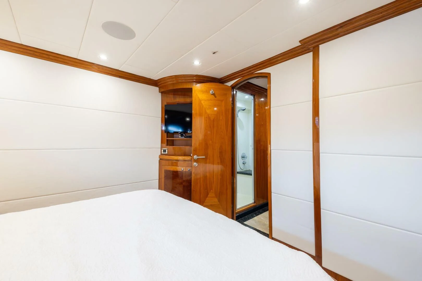 a bedroom with a bed and a closet aboard OCEAN 1 Yacht for Sale