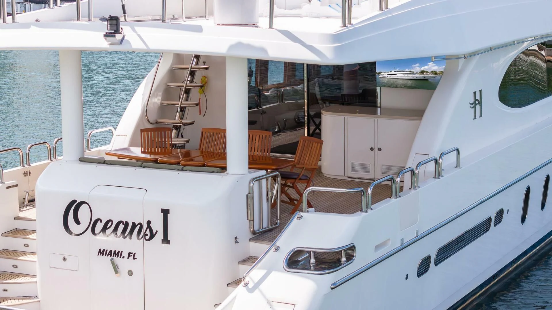 a boat with a table and chairs on the deck aboard OCEAN 1 Yacht for Sale