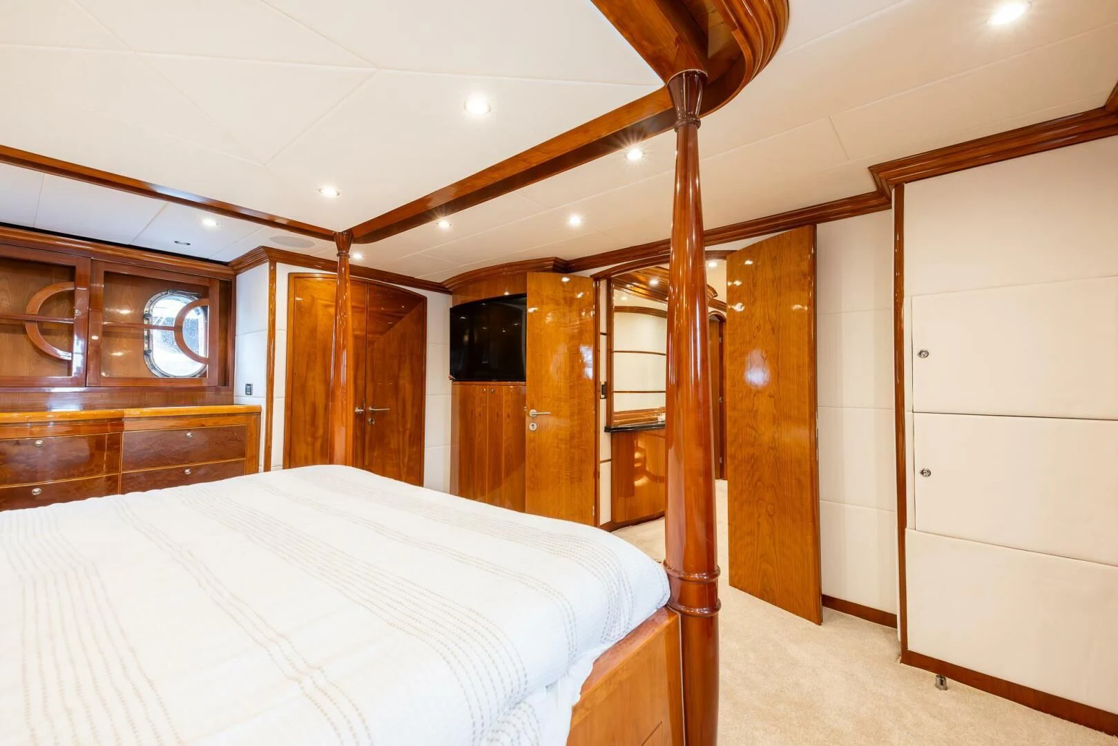 a bedroom with a bed and a wood door aboard OCEAN 1 Yacht for Sale